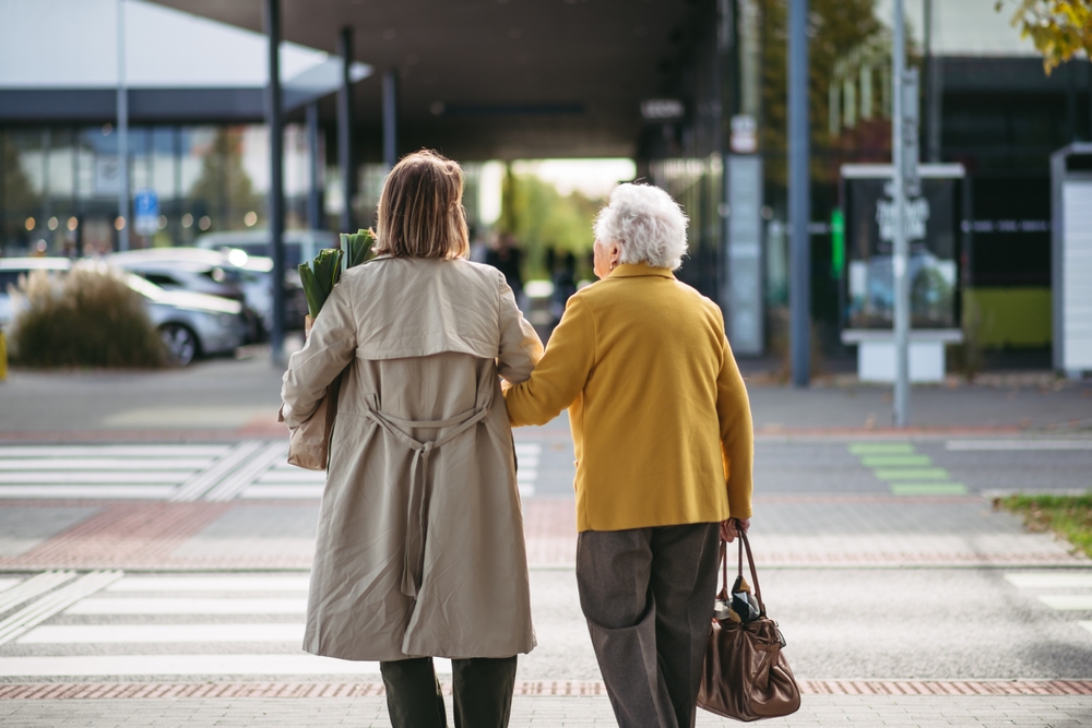 Caregiver walking with senior in respite care in Seattle, WA.