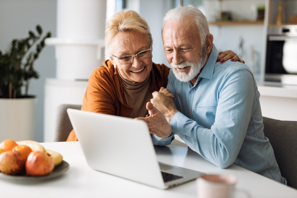 Senior couple on laptop in Senior Apartments in Lynnwood WA.