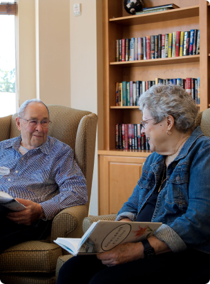 An older couple sitting in a library