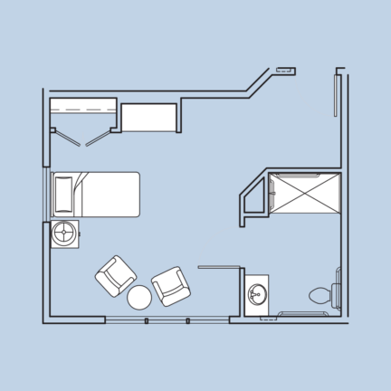 A simple room layout with bed, two chairs, table, sink, and private bathroom featuring a shower and toilet on light blue background.