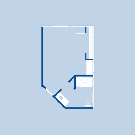 Blueprint of a small, irregularly shaped room with a visible bathroom area, including a shower and toilet. Simple and functional design.