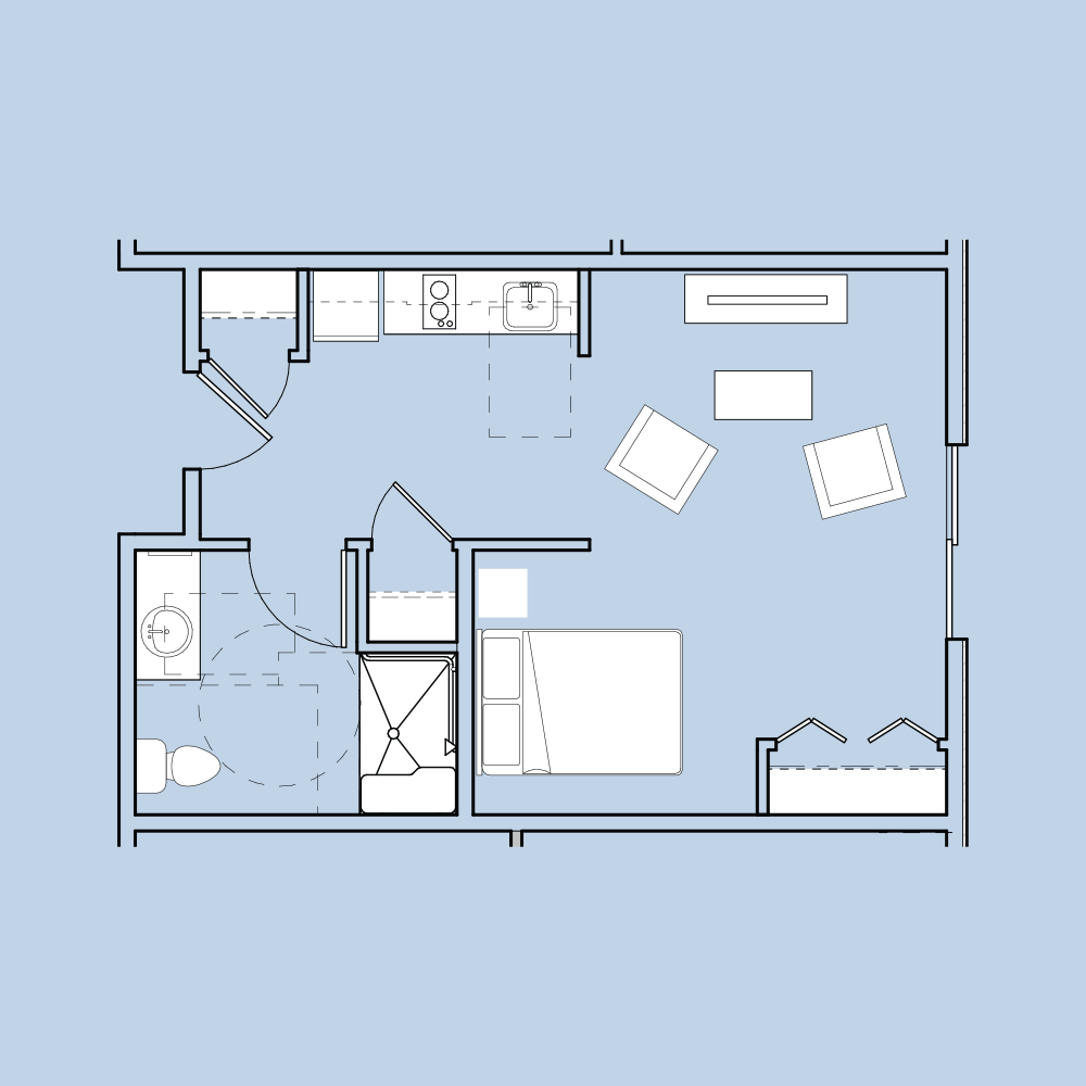 Floor plan of a modern studio apartment, featuring a bedroom, bathroom, kitchen, and living area with two chairs and a small table.