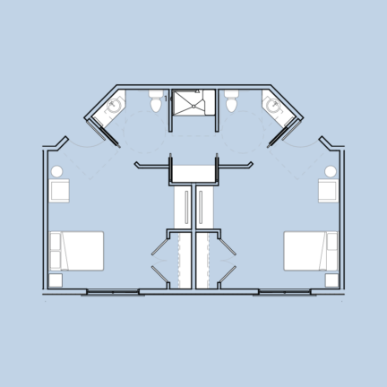 Floor plan of a hotel suite with two separate bedrooms, each with a bathroom, and a central shared living area.